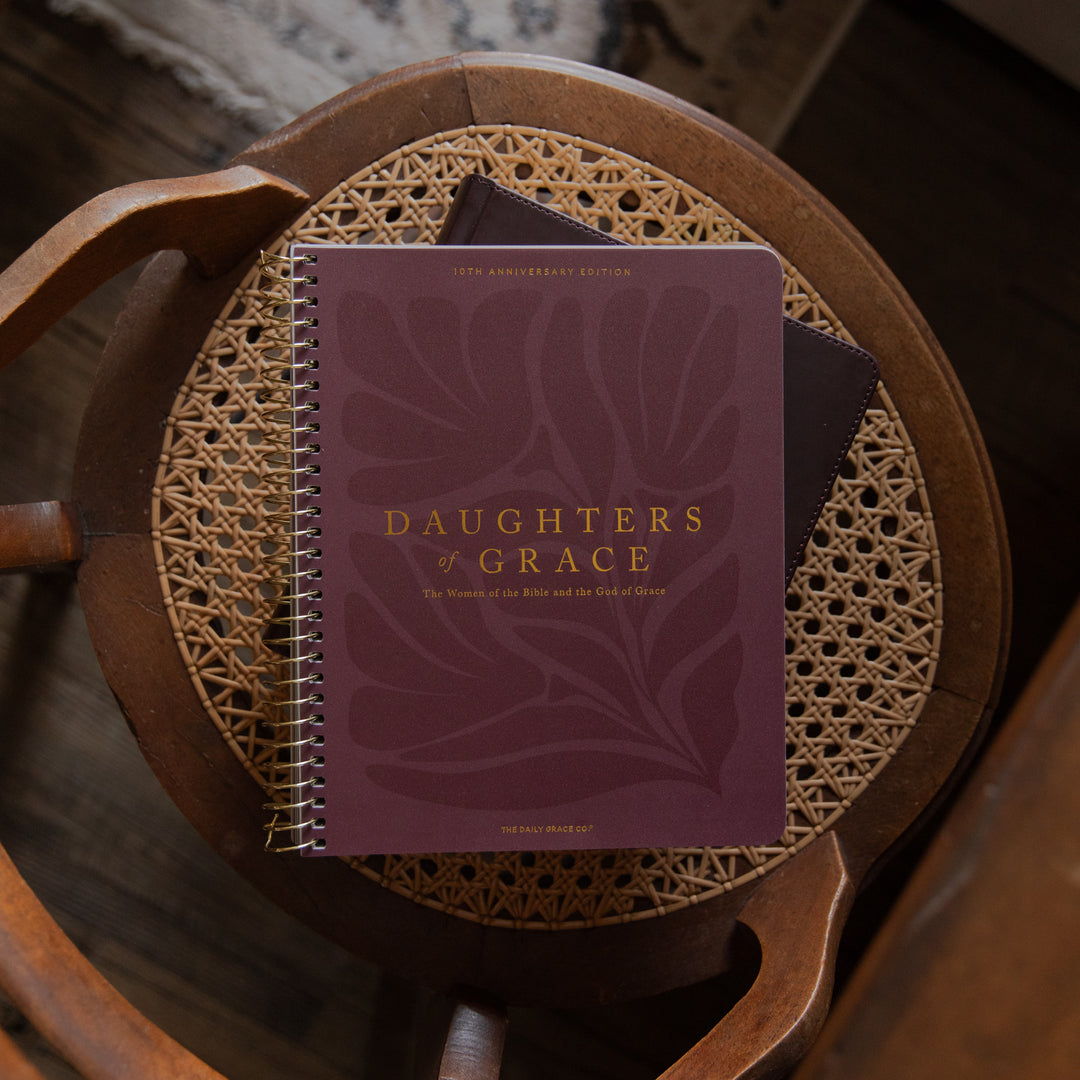 Purple Bible Study titled 'Daughters of Grace' on a wooden chair