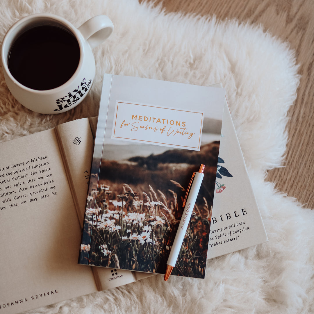 Meditations for Seasons of Waiting is closed on top of an open Bible