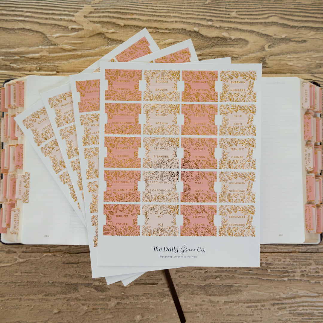 Sheet of decorative stickers with floral designs on a wooden surface