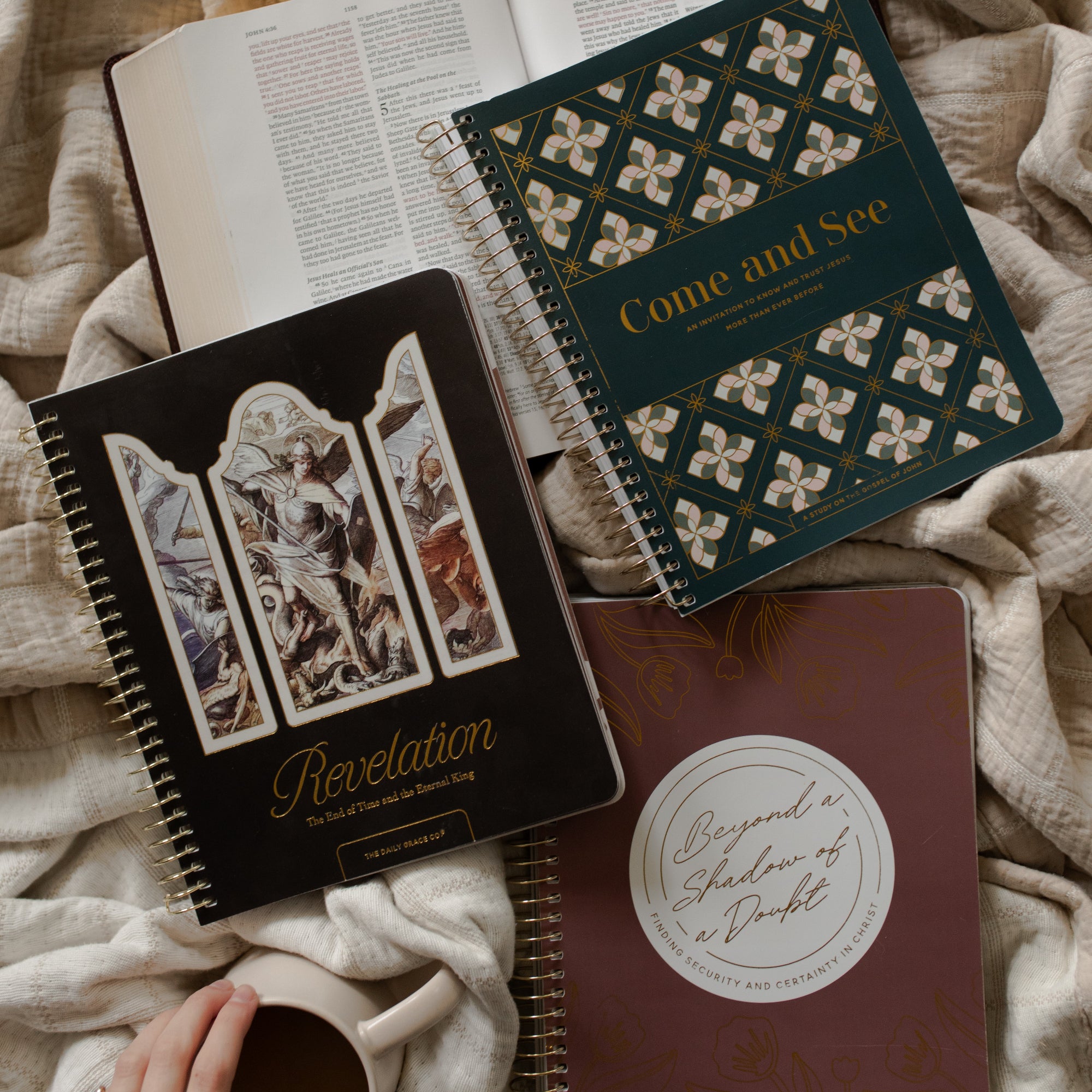 Come and See Bible study, Revelation Study, and the Beyond a Shadow of a Doubt study on an open bible and a creme colored blanket