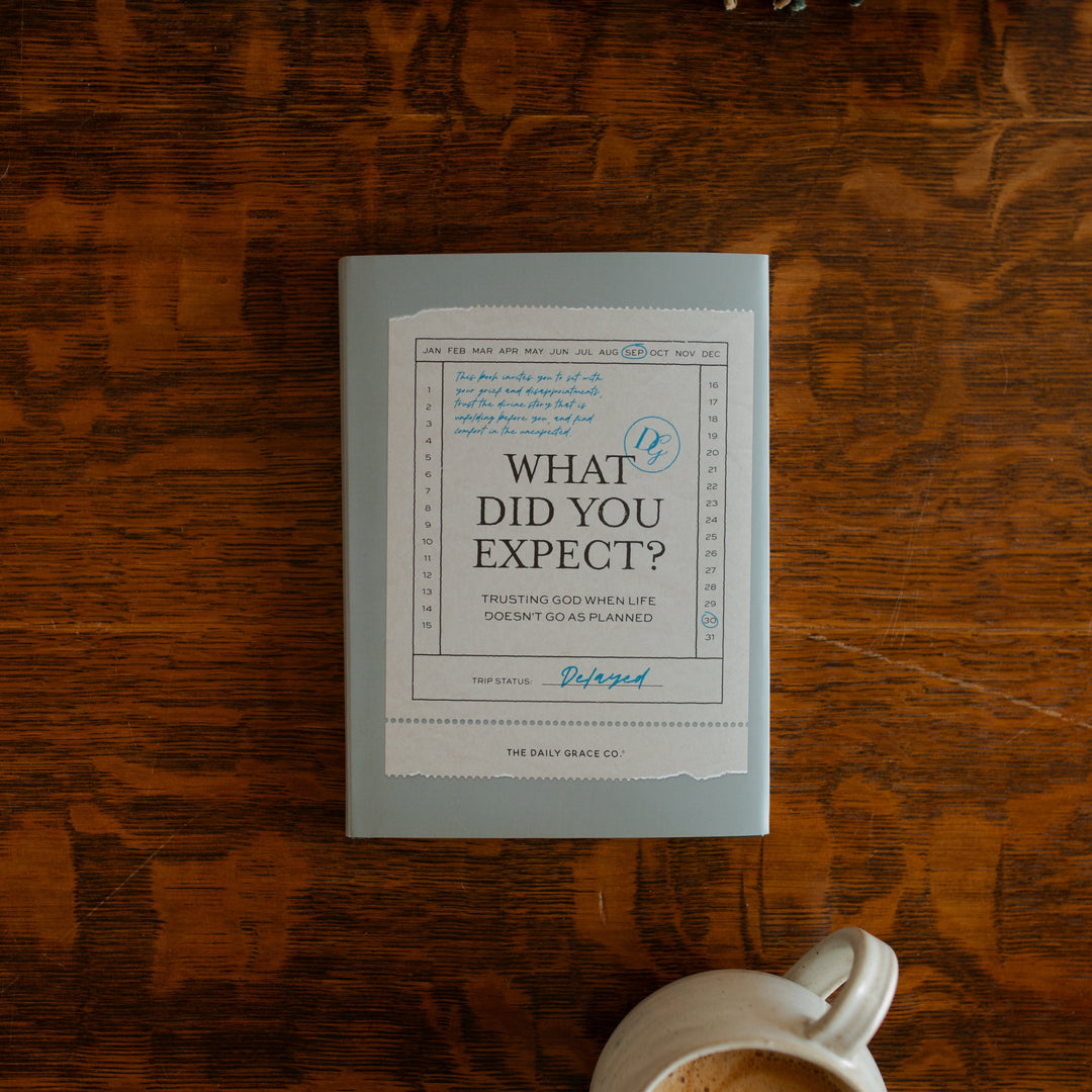What did you expect book cover on a wooden table near a coffee cup